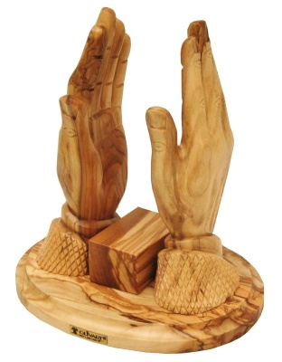 praying hands carrying bible