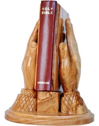 praying hands carrying bible